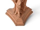 statue of a woman holding a bird on a pedestal