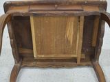 a small wooden table with a drawer on it