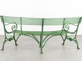 a green bench that is sitting in the middle of a room