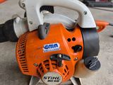 a chainsaw sitting on the floor in a garage
