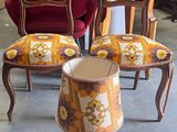 three chairs and a table with a lamp on it