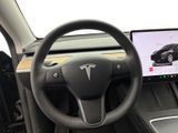 the interior of a car with a steering wheel, dashboard, and monitor