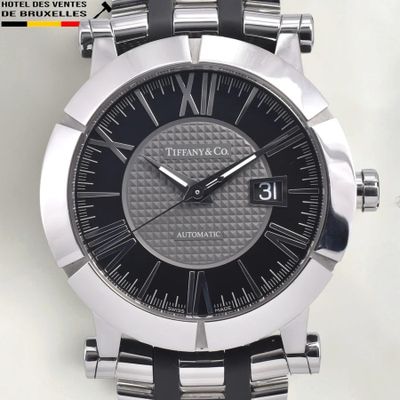 a close up of a watch on a white surface