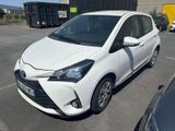 the toyota yaris is parked in a parking lot next to other cars