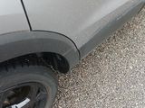a close up of a car ' s tire on a gravel road