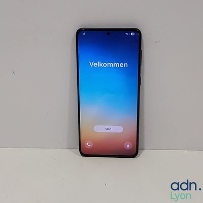 the back of a black samsung s9 phone sitting on top of a white table