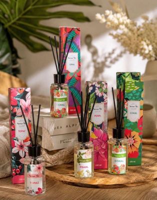 un assortiment de roseaux et de bougies sur une table ornée de fleurs