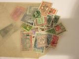 a pile of old postage stamps on a table