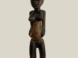 an image of a wooden statue of a woman holding a baby