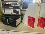 three boxes on the shelf of a store with a price tag