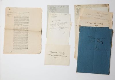 several pieces of old papers are on a white surface