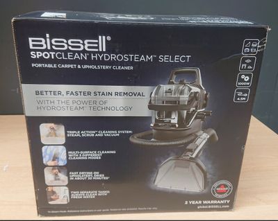 the box of the bissell spotclean hydrant select vacuum is on the table