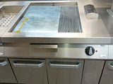 a large stainless steel counter top in a commercial kitchen
