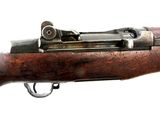 an old rifle with a wooden barrel and a metal handle
