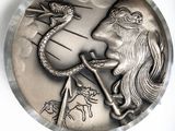 a silver coin with a picture of a man and a dragon on it