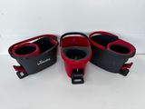 three pairs of red and black shoes are on a white surface