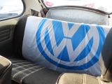 a pillow on the seat of a car with a vw logo on it