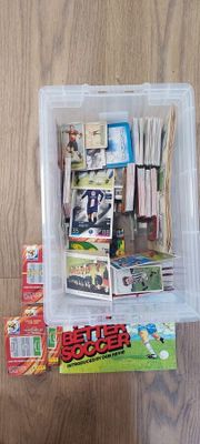 a plastic container filled with assorted items on a wooden floor