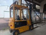 a yellow forklift truck parked in front of a building