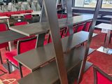 tables and chairs in a restaurant with a red carpeted floor