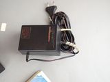 a charger that is sitting on a table next to a book