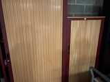 a room with two doors and a chair next to it