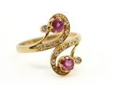 gros plan d'une bague en or avec deux rubis