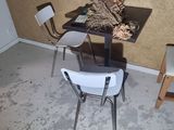 two chairs and a table in the corner of a room
