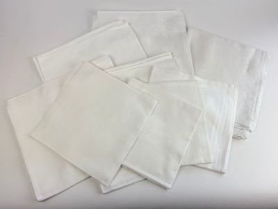 several white napkins on a white table with a white background