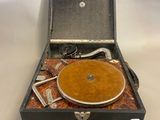an old record player sitting inside of a suitcase