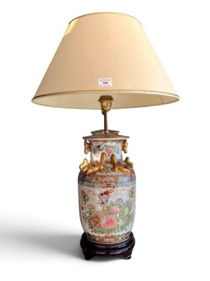a lamp that is sitting on a table with a lamp shade on it