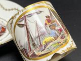 a cup and saucer with a picture of a boat on it