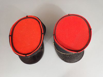 pair of black and red leather stools with red cushions