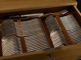 many forks and spoons in a wooden box