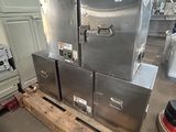 three stainless steel ovens sitting on a pallet in a warehouse