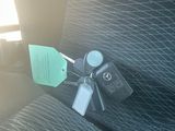 a key in the back seat of a car with a tag attached to it