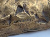 an image of a close up of a bronze statue of a dog