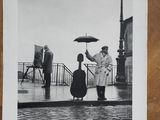 a black and white photo of a man holding an umbrella