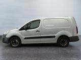 the white van is parked on the concrete floor in the room