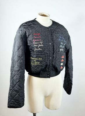 veste matelassée noire avec une inscription, présentée sur un mannequin