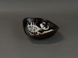 a black and white bowl with a fish design on it