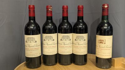 six bottles of wine are lined up on a wooden tray