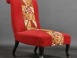 an image of a red chair with a patterned seat and legs