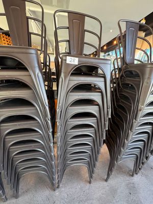 de nombreuses chaises empilées les unes sur les autres dans une pièce
