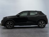 the black suv is parked on the concrete floor in the room
