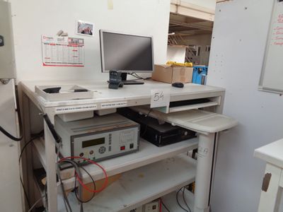 a computer desk with a monitor and other electronics on it