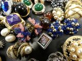 many different types of jewelry on a black surface