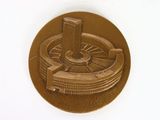 a picture of a gold medal with a picture of a building