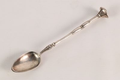 a spoon that is sitting on a white surface