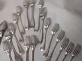 a lot of forks and spoons that are on the table